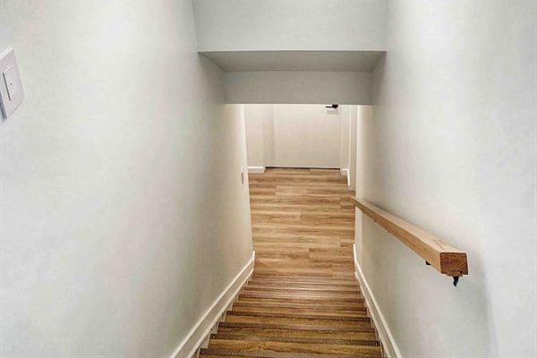 Shared entry and stairway leading to the lower-level guest suites.