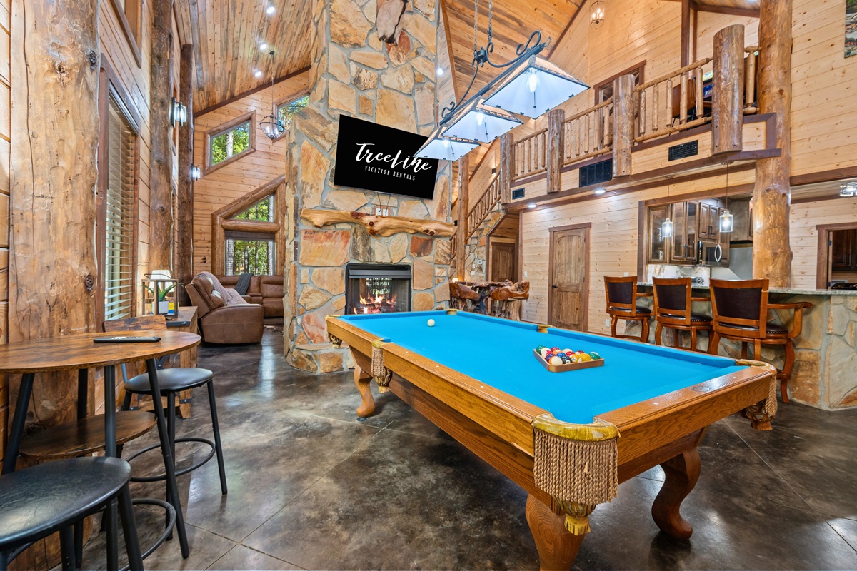Spacious game room with pool table and open loft design.