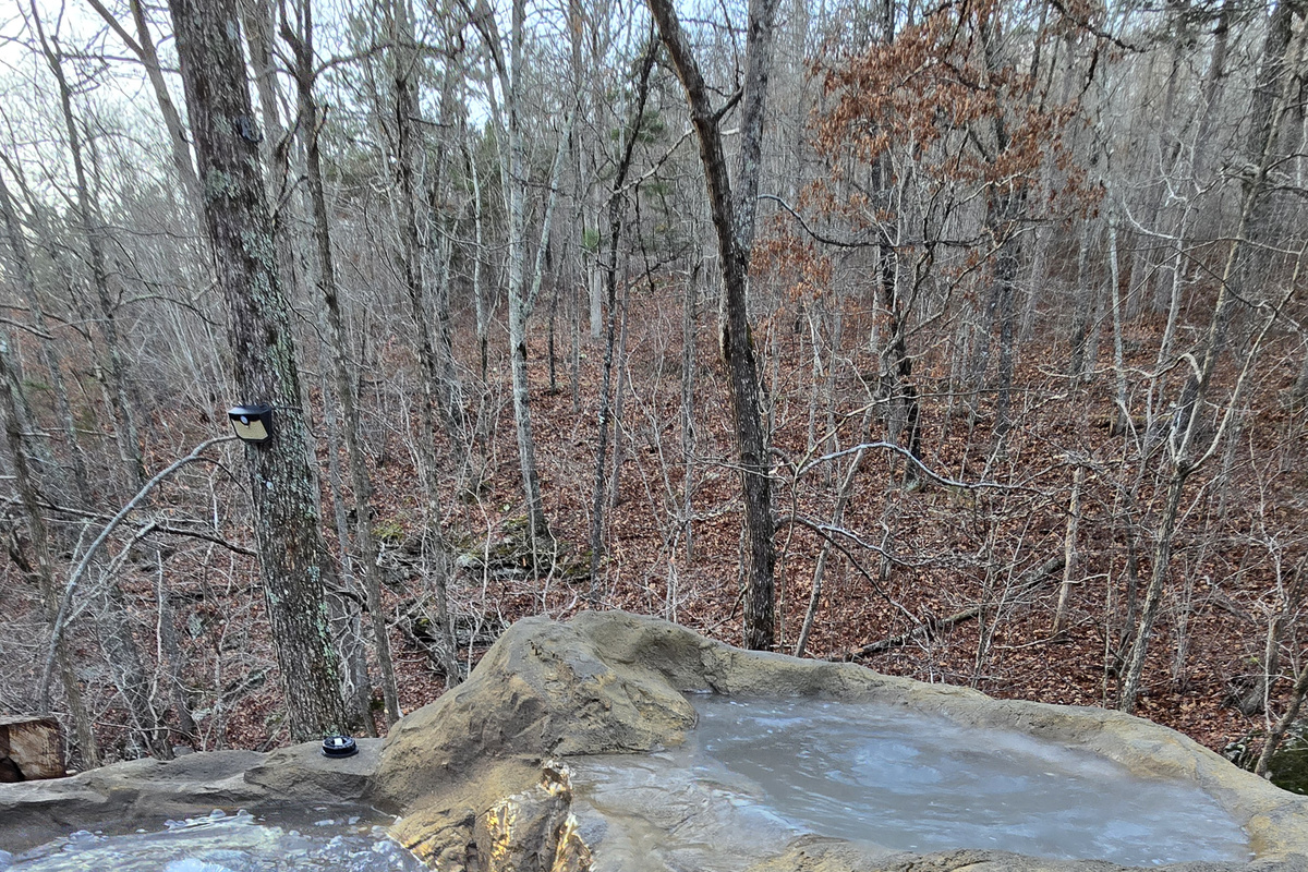Boulder Hot Tub With Waterfall next to the creek and falls
