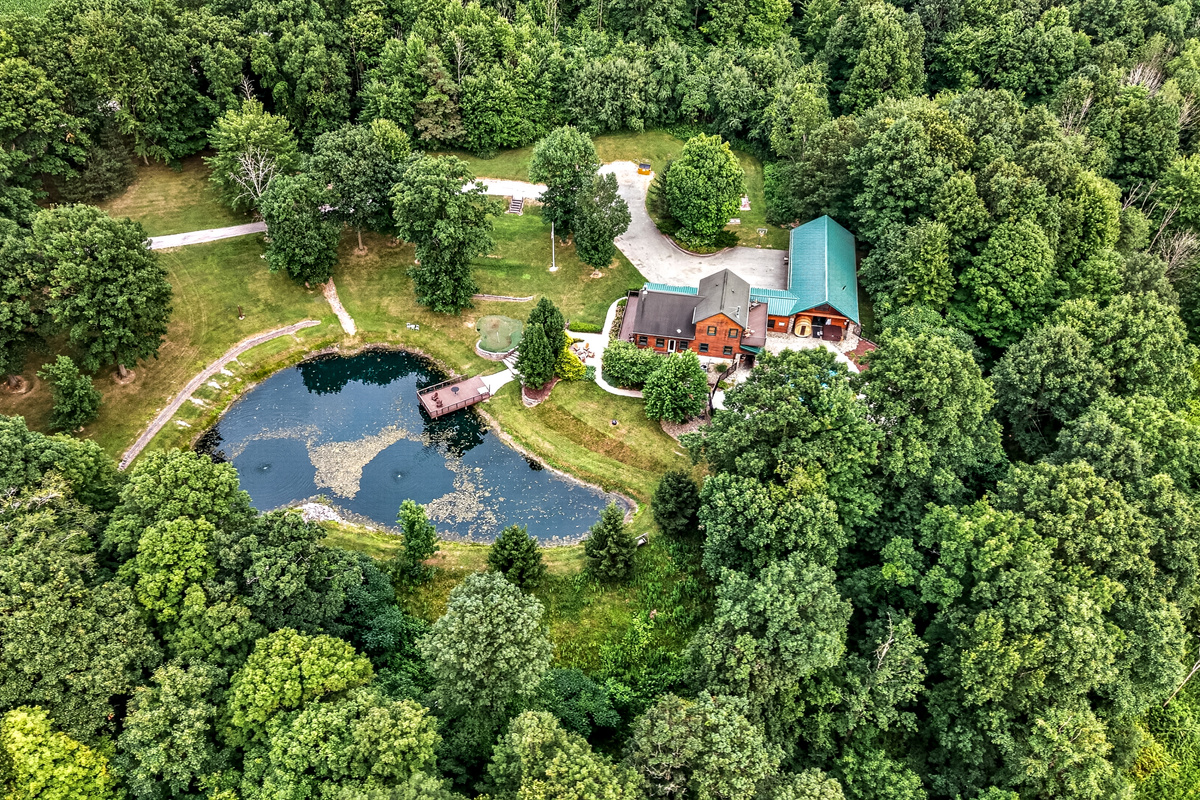 Wooded property with pond and house