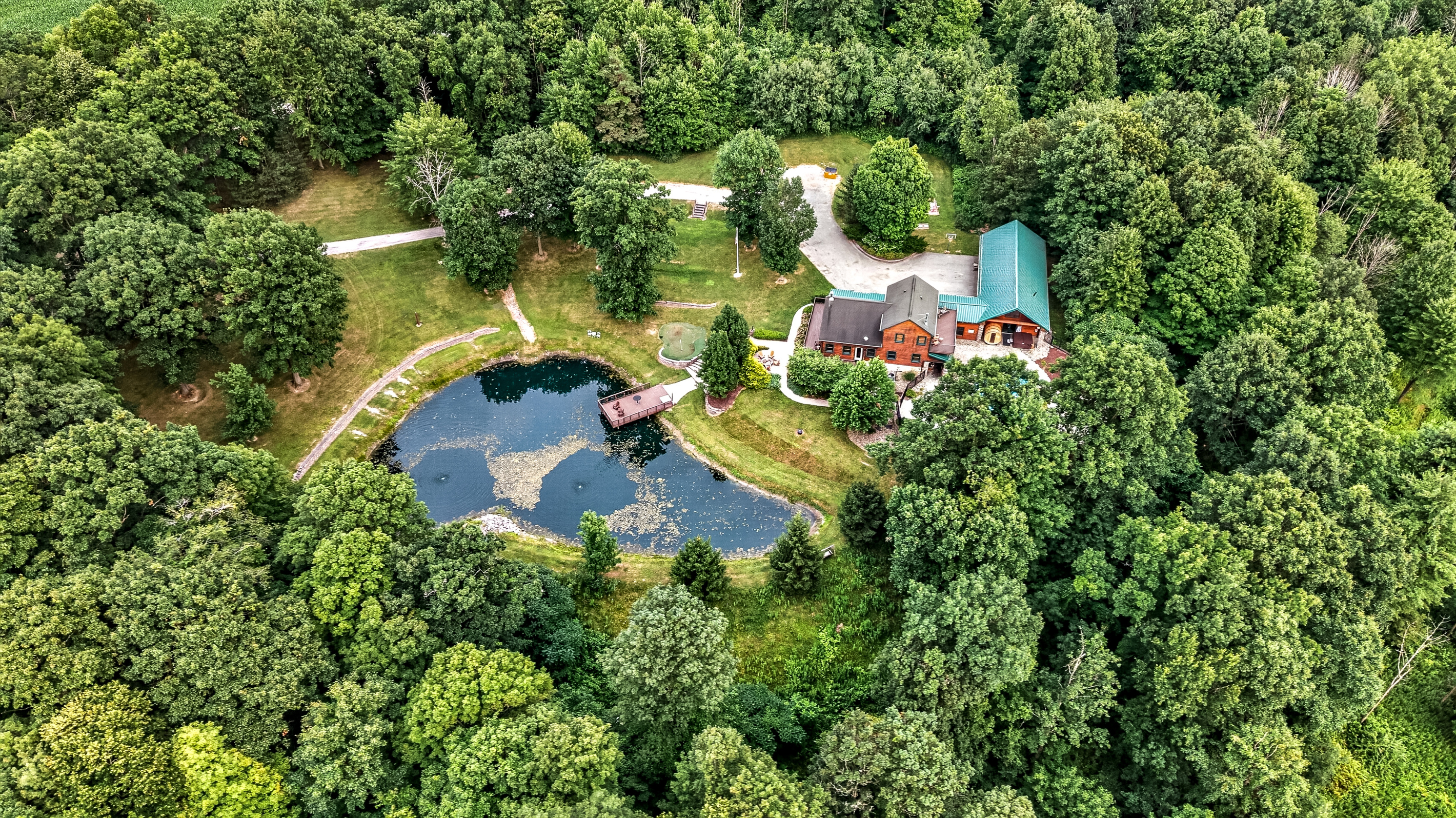 Wooded property with pond and house