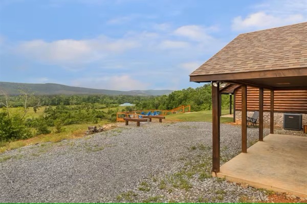 Covered side patio with open views toward the deck and valley.