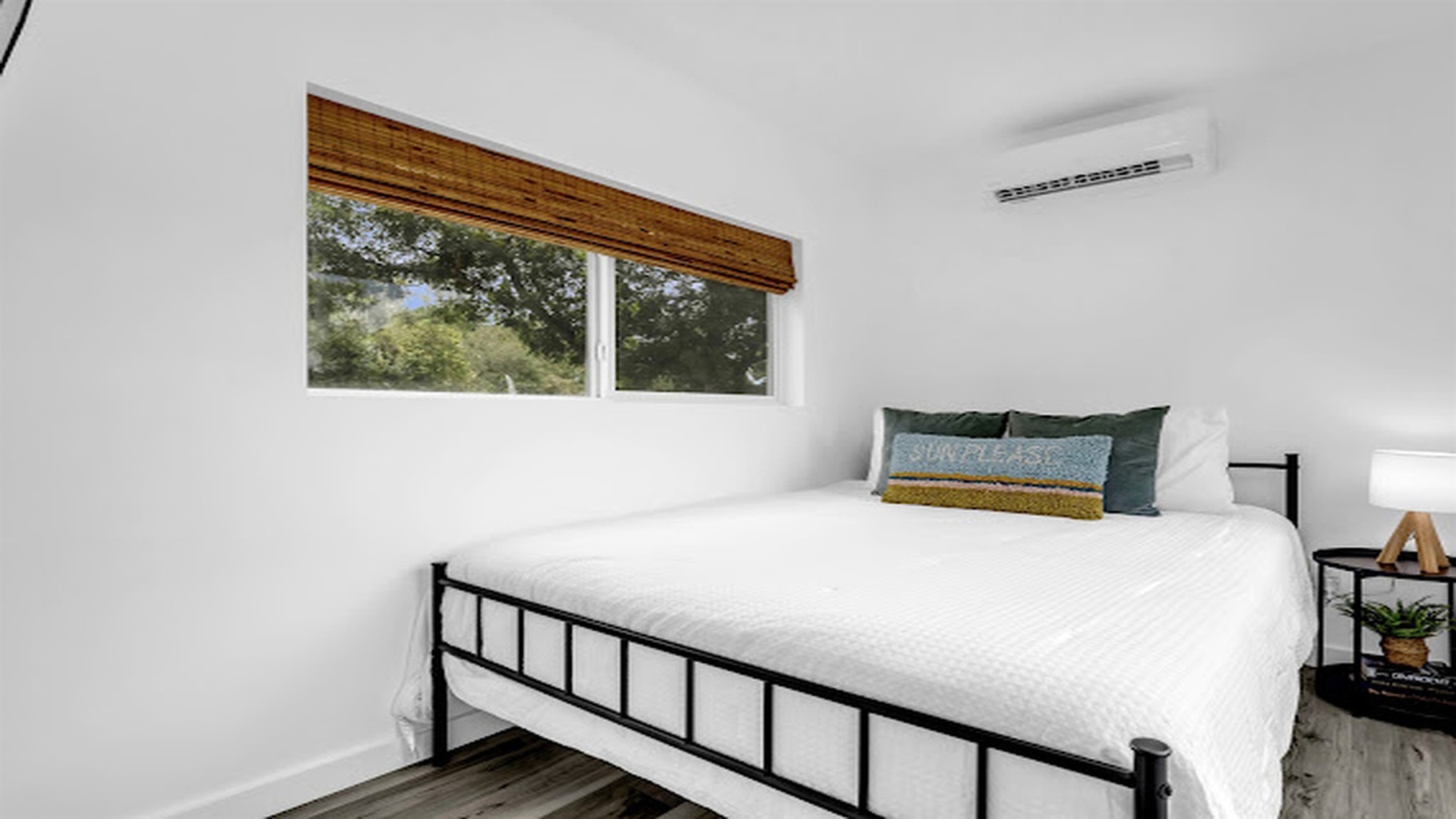 Peaceful bedroom with cozy linens and calming nature views.