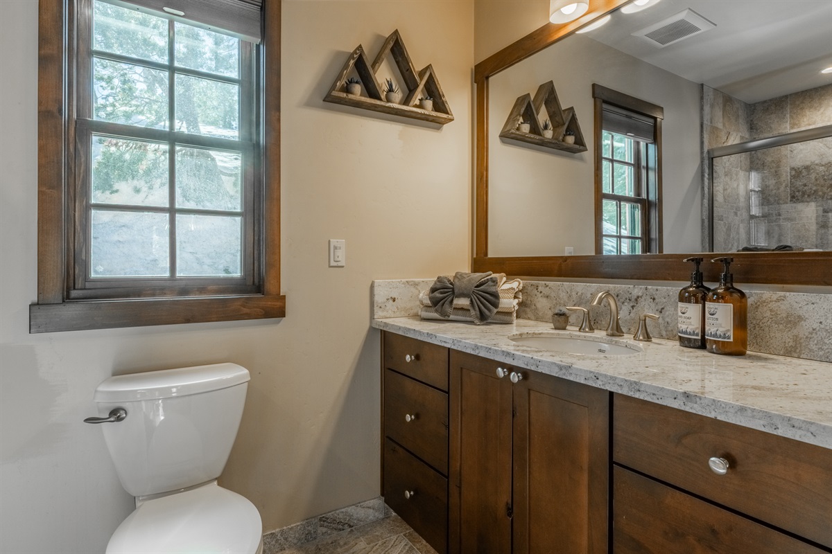 Conveniently located on the main floor, this full bath with tub/shower combo serves both the living area and bunkroom—perfect for freshening up after a day of adventure.