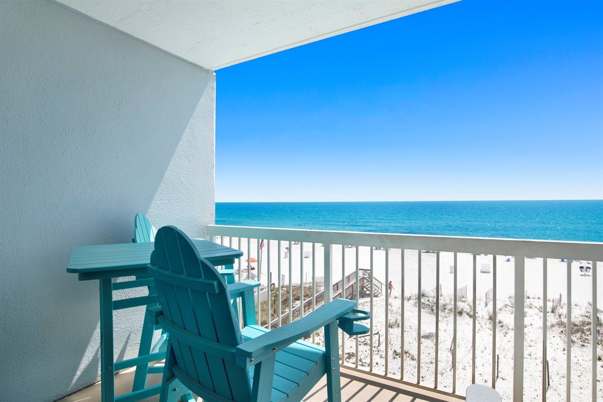 Private beachside balcony with seating and table