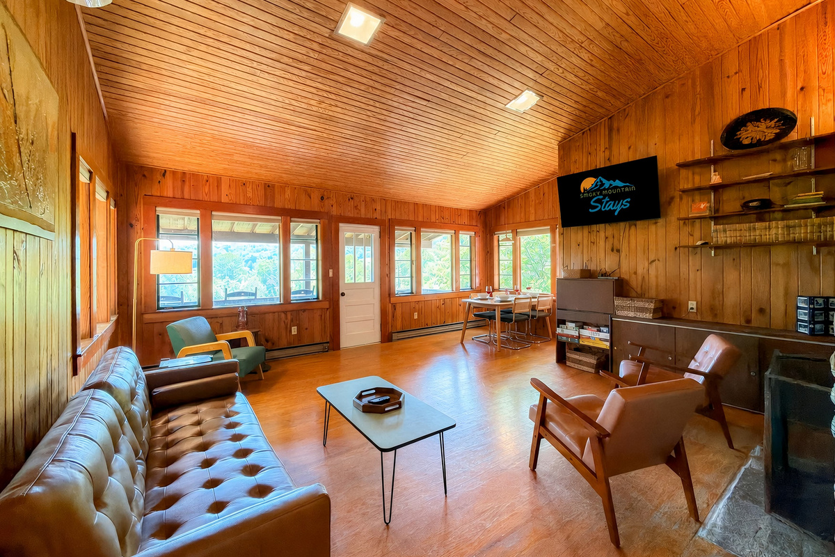 Our spacious and cozy living room features a mixture of old and new nostalgic furniture,  a 55" Smart TV, views of Sharp Top and the National Park.