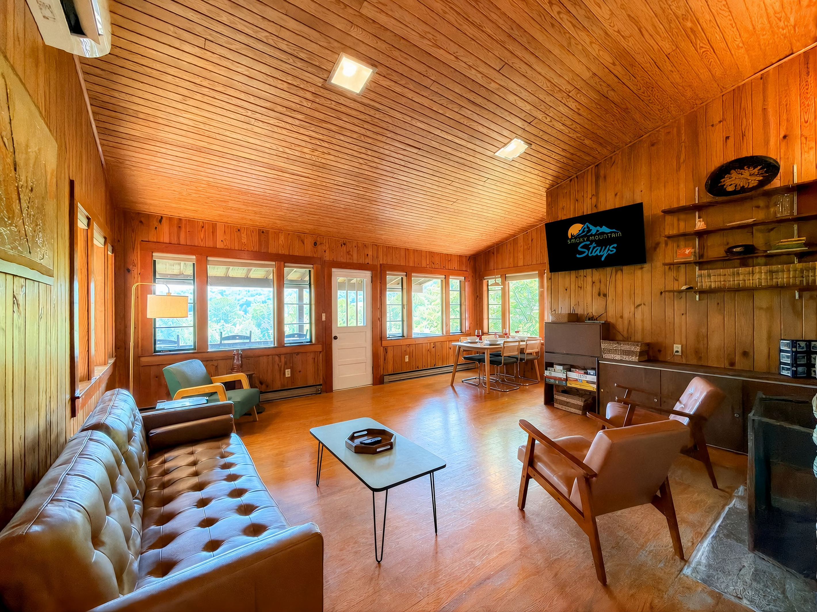 Our spacious and cozy living room features a mixture of old and new nostalgic furniture,  a 55" Smart TV, views of Sharp Top and the National Park.