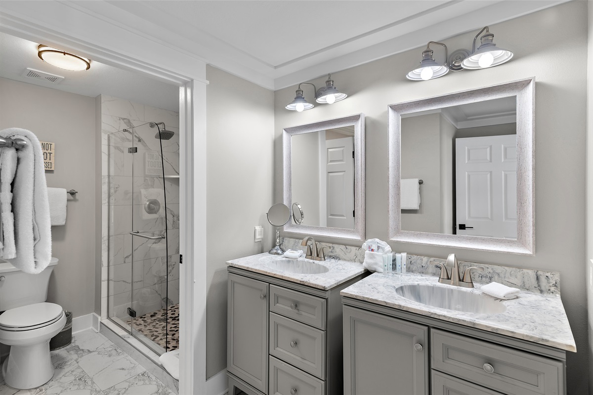 Primary bathroom is remodeled with dual vanity and luxurious, marble, walk in shower - a rare upgrade for condos in the building!