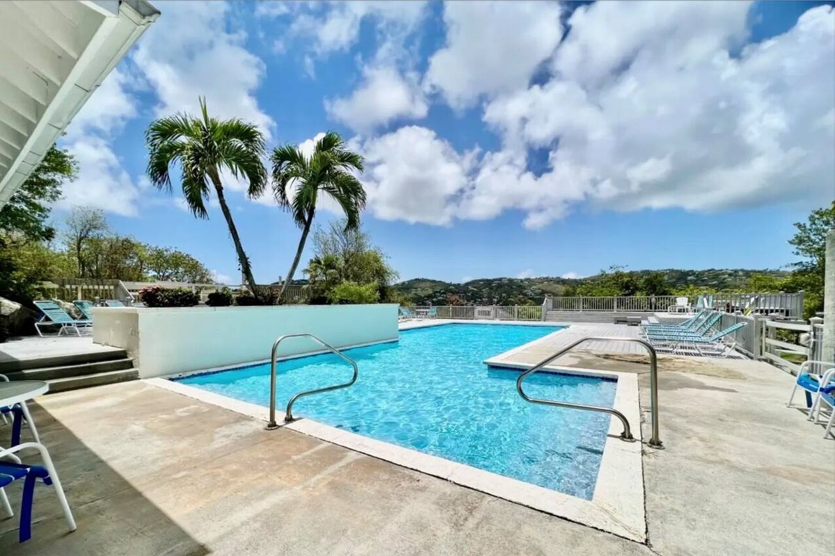 Community pool just a short stroll away; dip into relaxation under the palm trees.