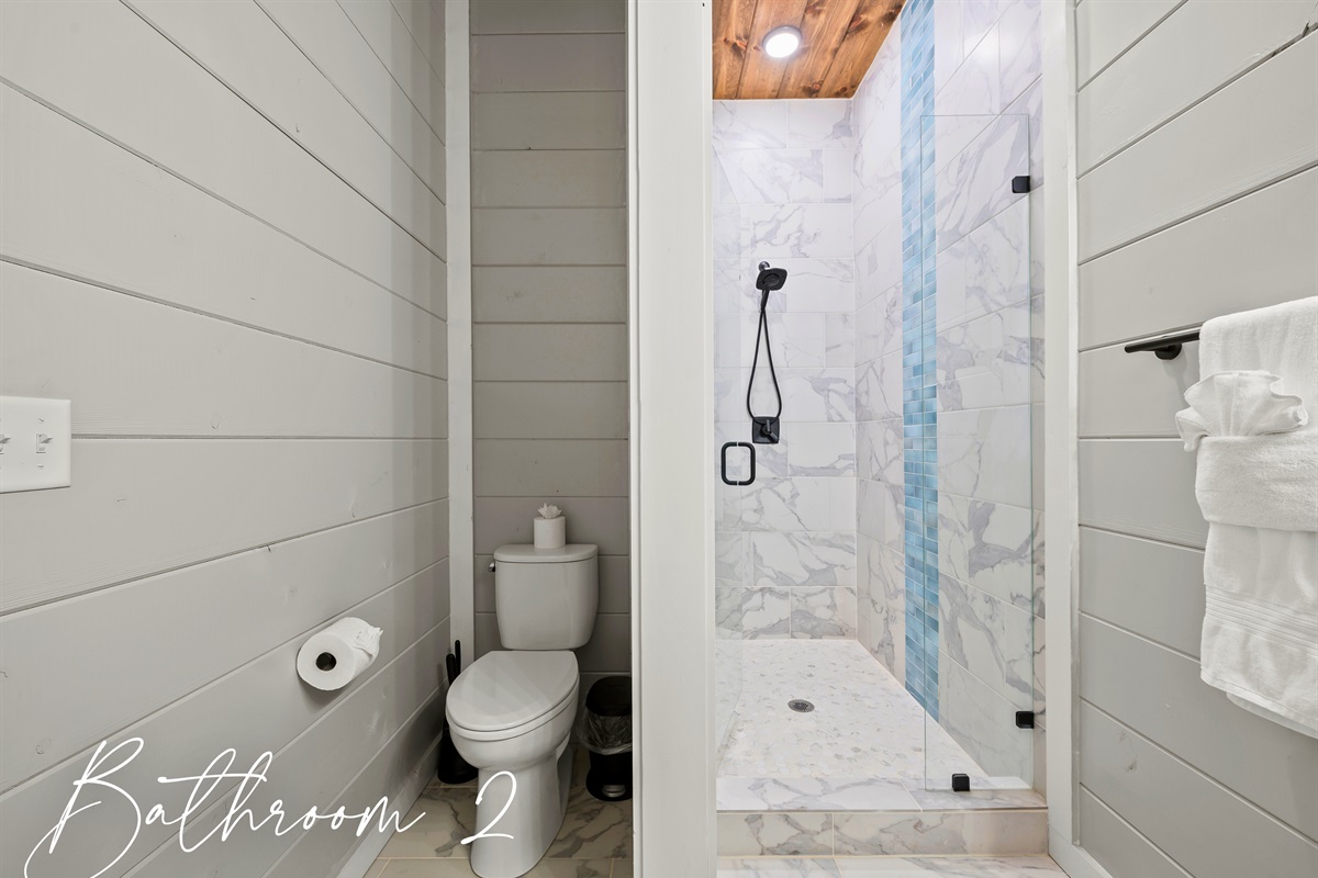 Bathroom 2 combines modern elegance with rustic touches, offering a tiled shower for a refreshing start or end to your day.