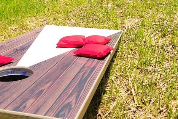 Open lawn for yard games including cornhole, Jenga blocks and large yard Pong set.