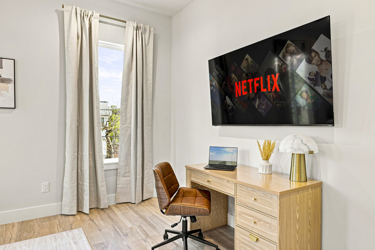 Bright, stylish desk area with smart TV for work and play in Dallas!