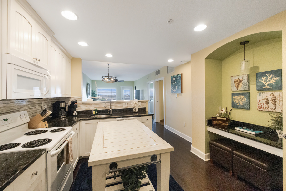 Kitchen - fully equipped w/ a microwave, dishwasher, full size fridge, Mr. Coffee, range, stackable washer/dryer, pots/pans, dishes and silverware.