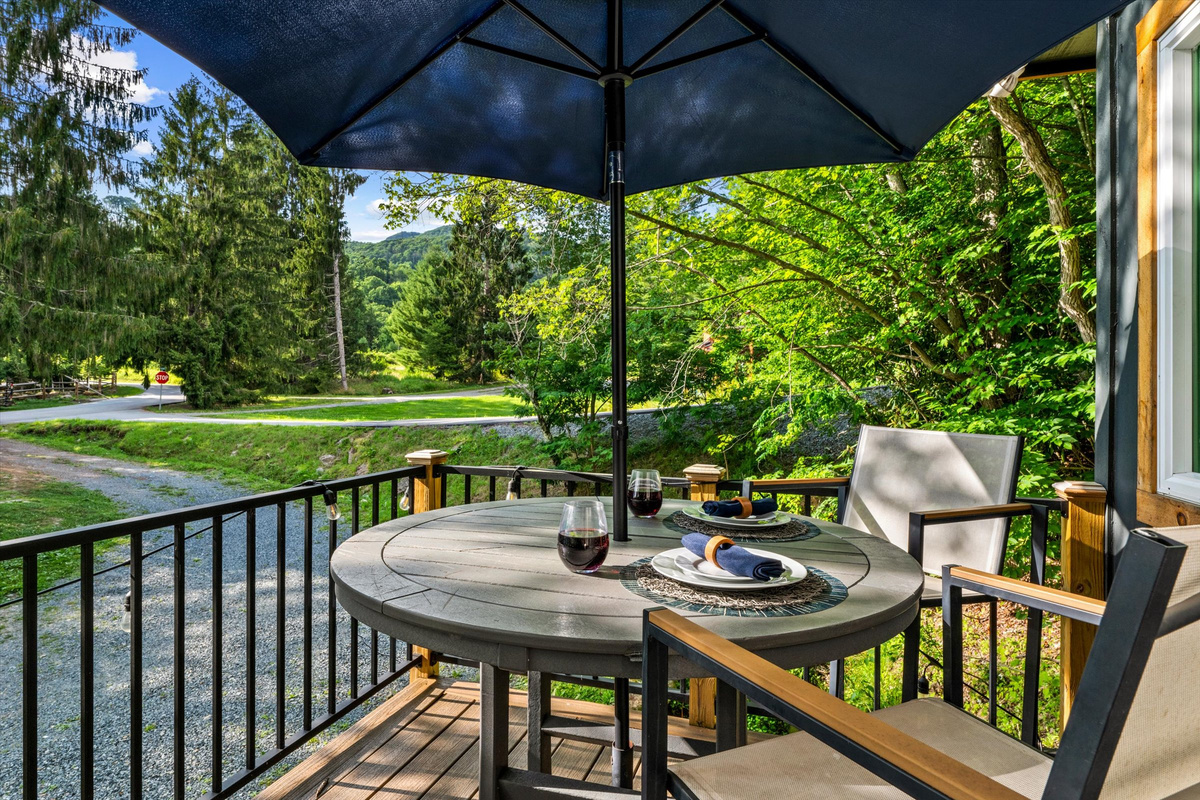 Deck with Blackstone Grill, cafe lights, bistro table and sitting chairs