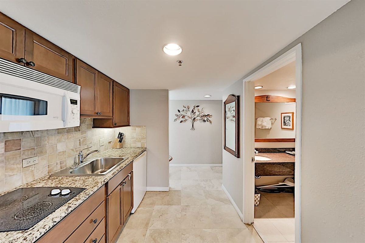 Kitchenette stocked with dishware, cutlery to prepare light meals
