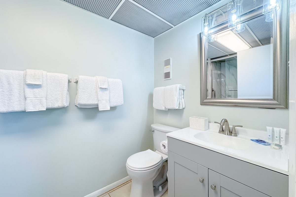 Freshly updated bathroom featuring a shower/tub combination, ample vanity space, and modern fixtures.