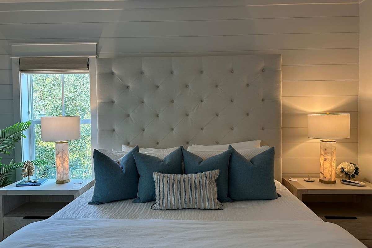 Spacious 2nd level king bedroom suite with full ensuite bathroom, tiled shower, dual vanity sinks, and newly remodeled outdoor shower.