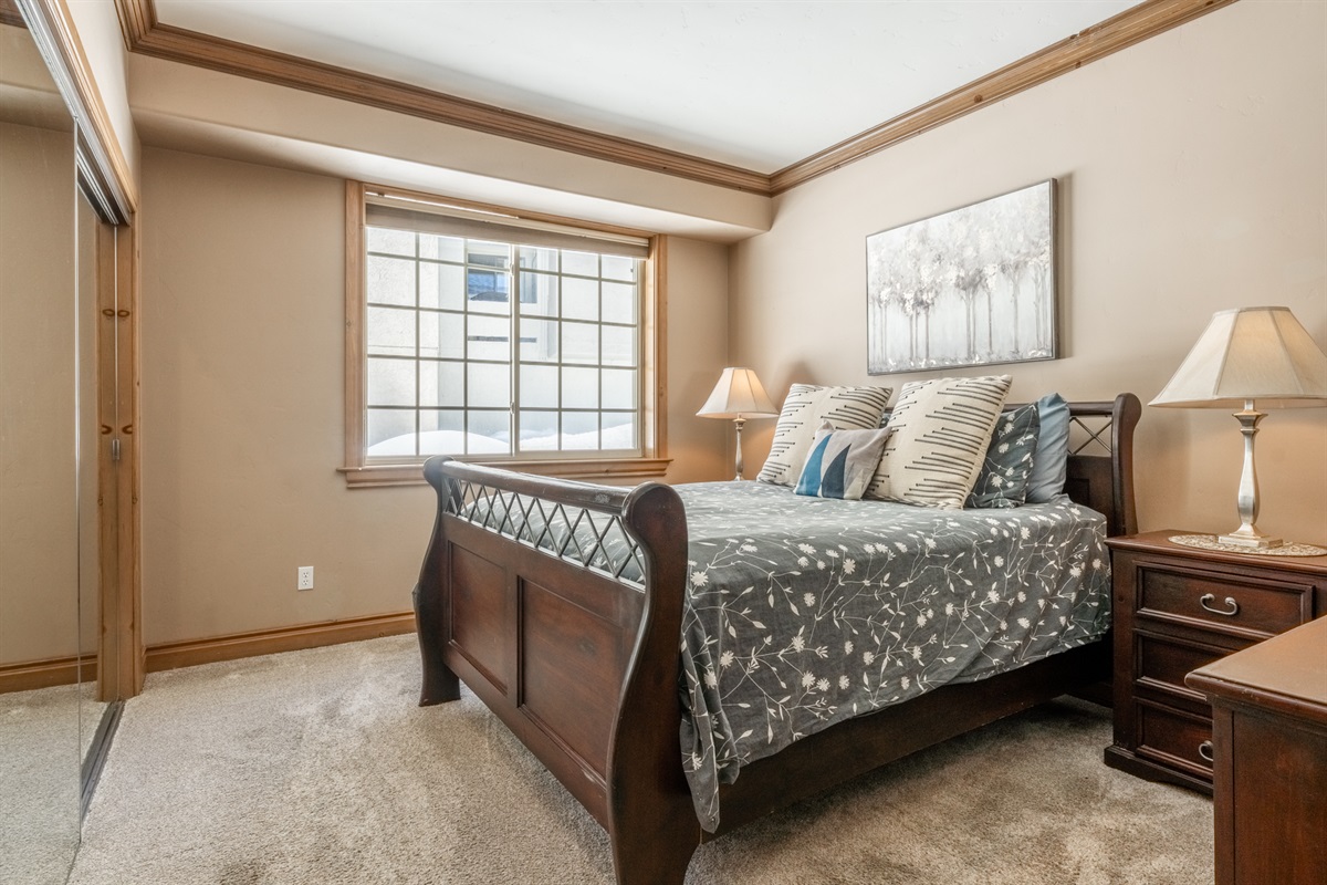 The Nest's comfortable guest bedroom with a queen bed, large closet, and tranquil natural light—ideal for adults or older kids.