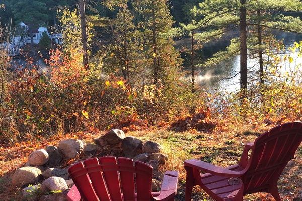 Restful lakeside scene at firepit in front of cottage