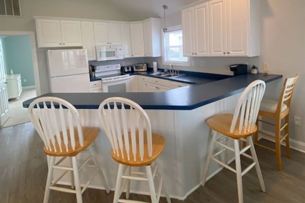 Bright, open kitchen with bar seating for four.