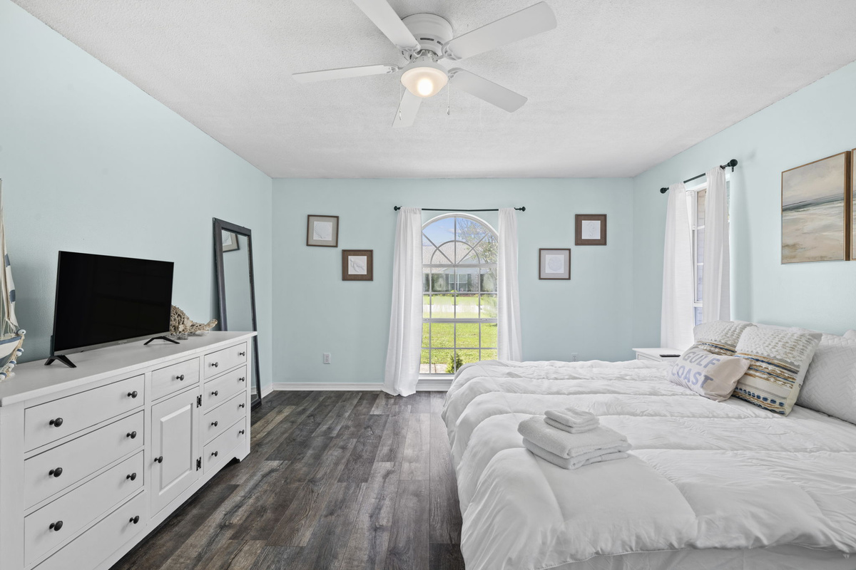 Room to unwind, with a TV for movie nights and a full-length mirror for getting ready before beach days.