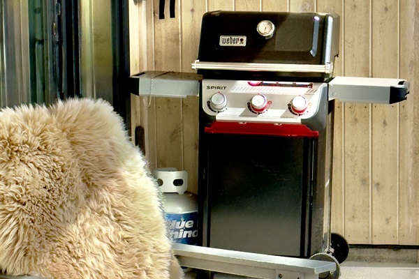 Weber gas grill on the covered patio