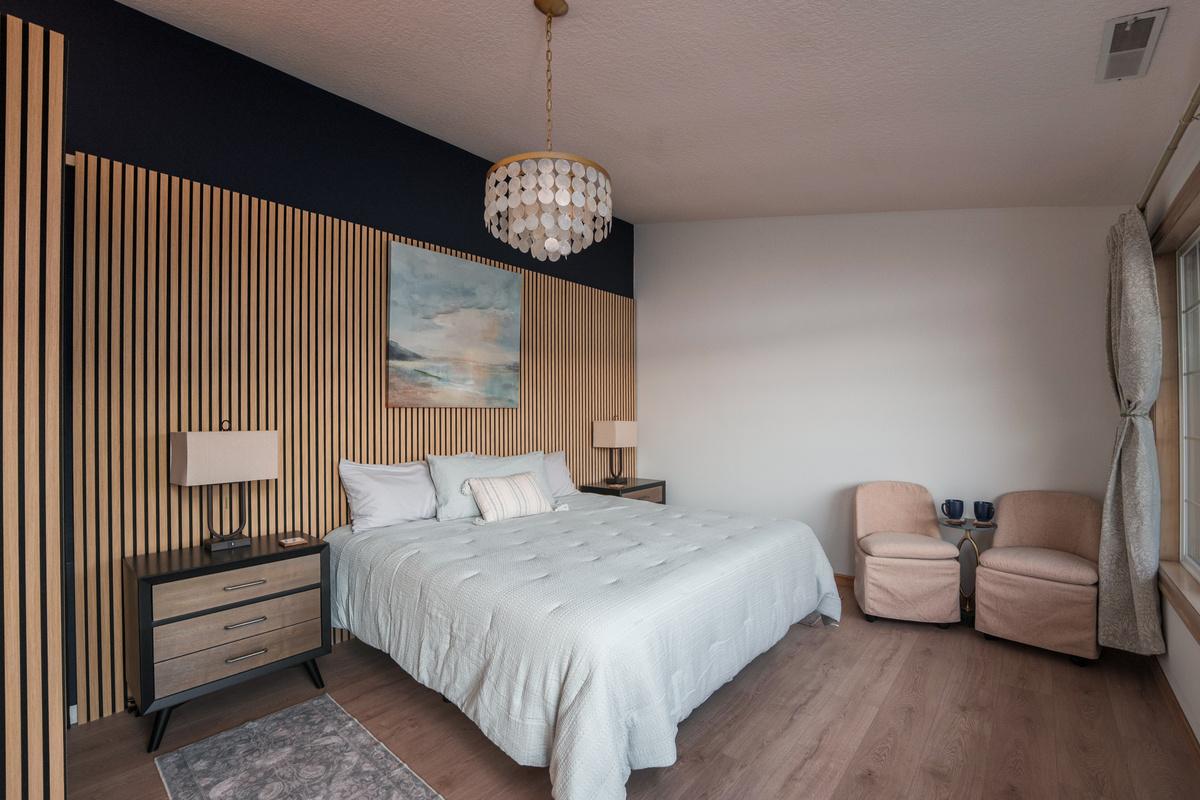 Wake to peaceful lake views from this king bedroom for two, complete with an adjoining nursery and convenient access to Bathroom 3, shared with Bedroom 3.