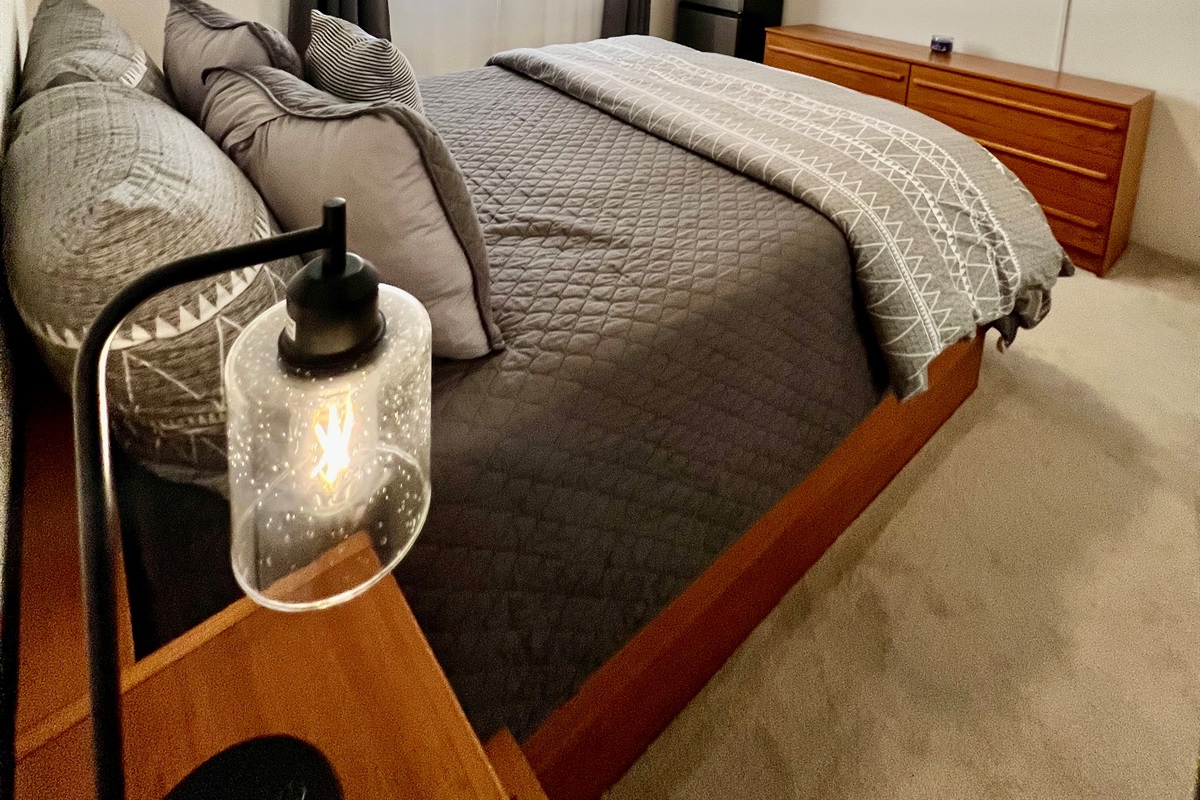 Your private guest getaway. This bedroom offers a plush Queen bed and a personal Smart TV, plus the added convenience of an in-room mini-fridge.