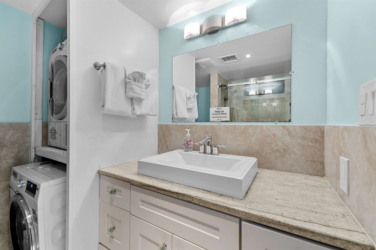 Main floor full bathroom has a shower, toilet and the washer and dryer