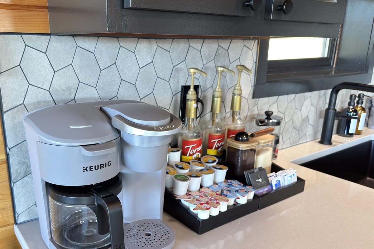 Coffee bar includes a Keurig drip/k-cup combo machine + flavor syrups, sugar, creamer, etc