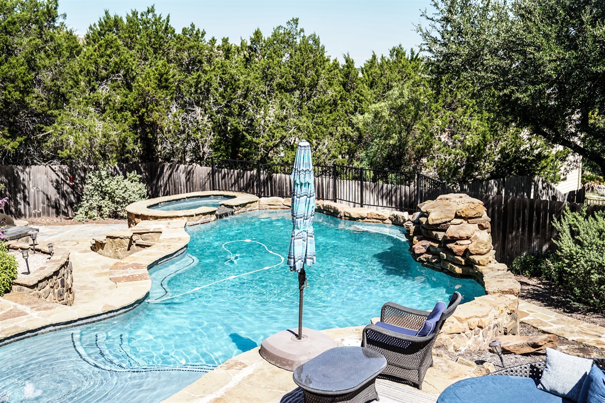 Private pool with hot tub and lounge area. 
