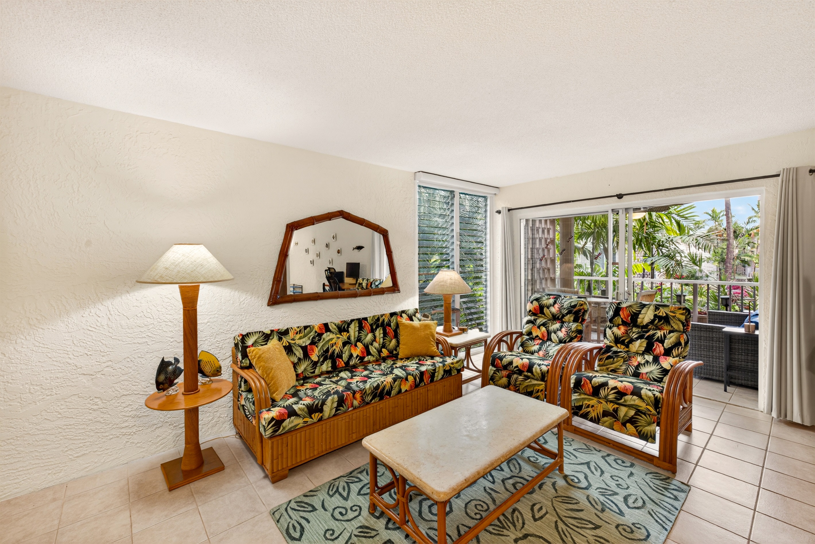 Bright, open-concept living space with comfortable tropical furnishings and plenty of natural light—perfect for relaxing after a day exploring the island.