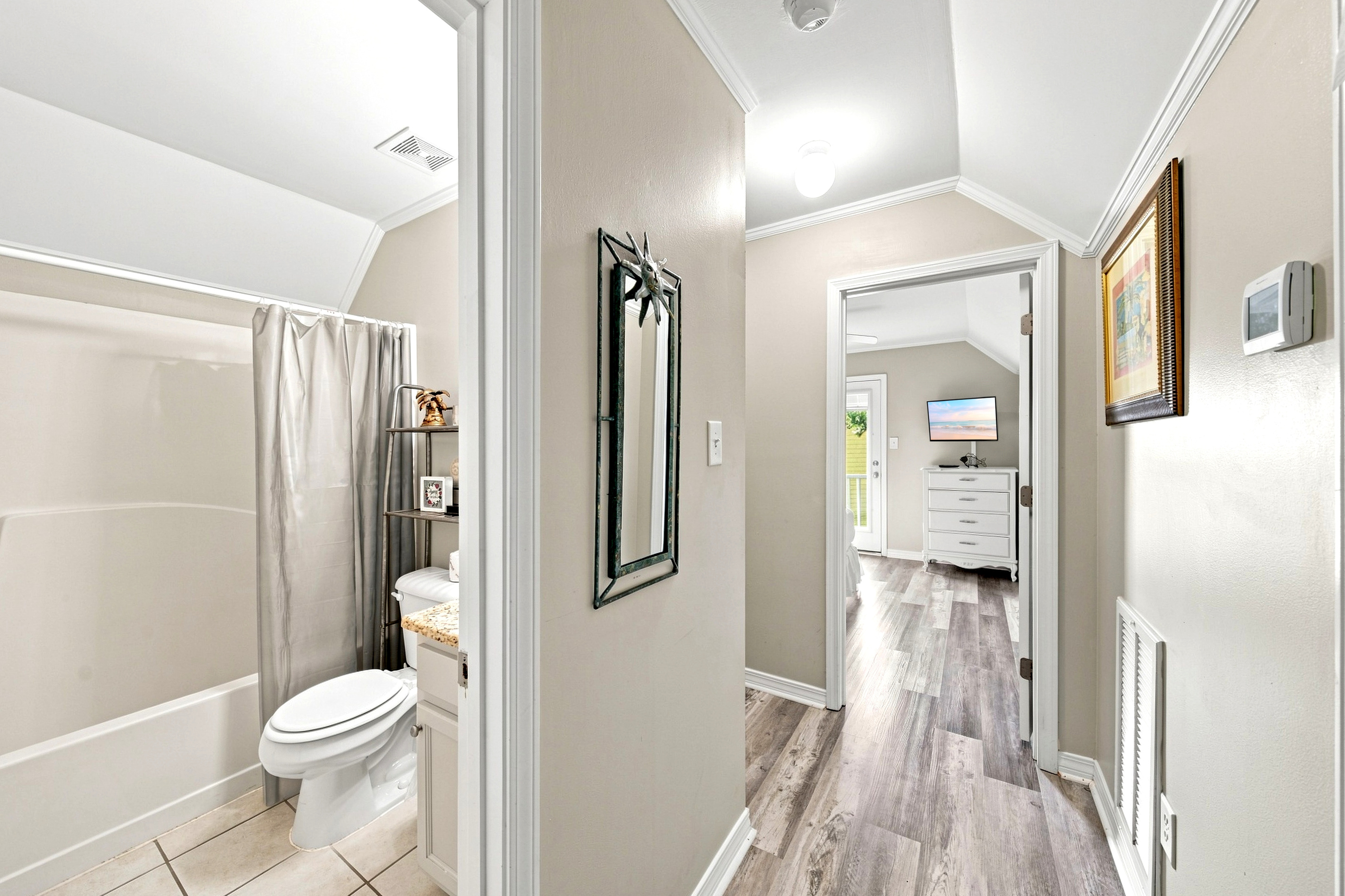 The upstairs guest bathroom features a full tub/shower combination, shared by both guest bedrooms.