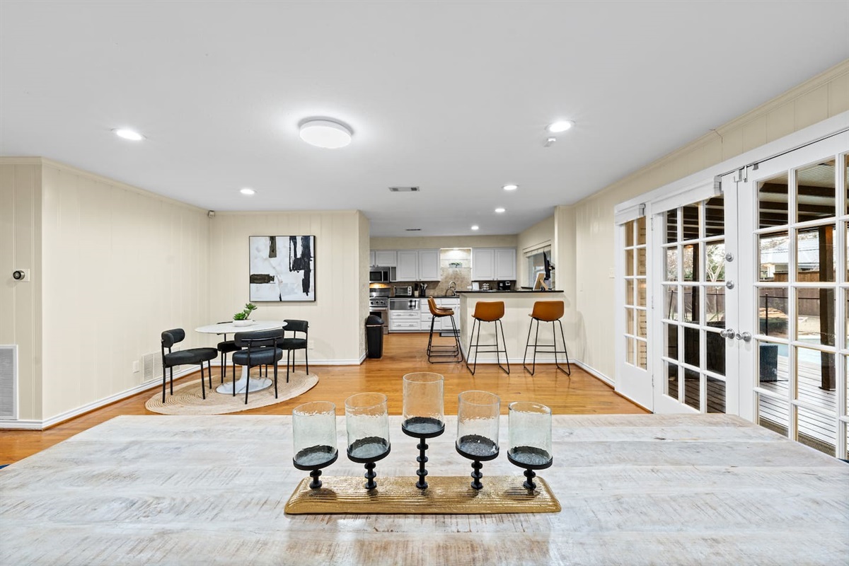 Chic table centerpiece sets the tone—full view of the open-concept kitchen, dining, and lounge space made for entertaining.