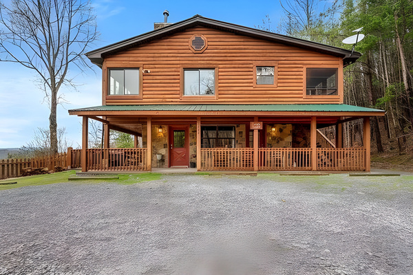 Your private cabin retreat. Simply Golden features a wrap-around porch, a fully fenced side area, and a welcoming main entrance nestled in nature.