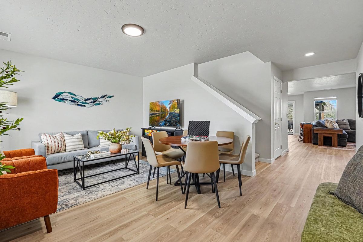 The front living room offers a comfortable space for guests to relax, watch TV, visit with friends and family, and enjoy playing games together.