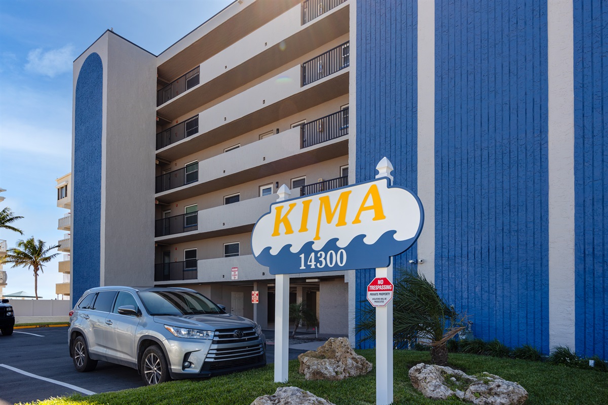 Kima sign in front of building