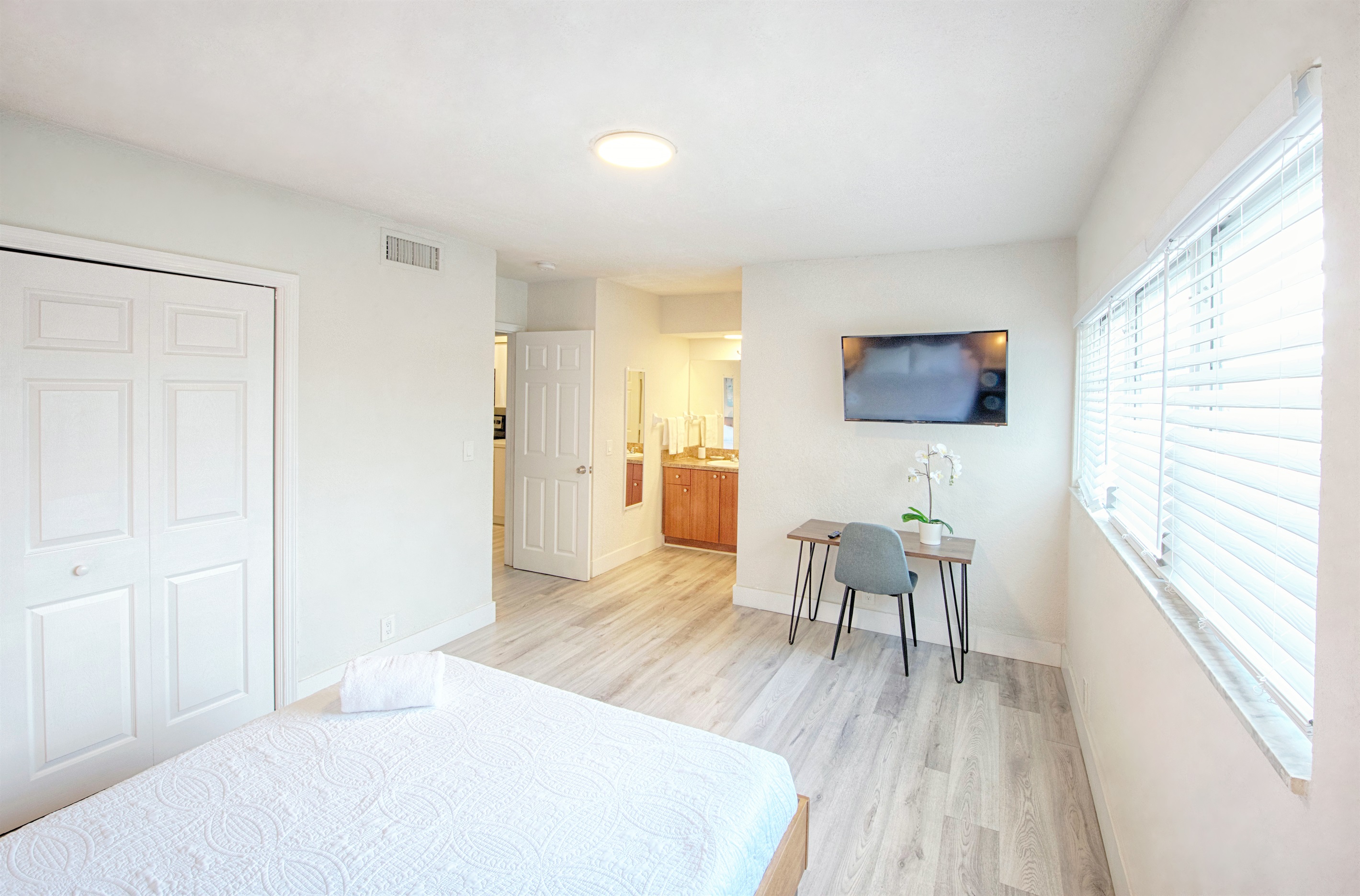 Featuring dining table and 39" Roku smart TV En suite bathroom entry in view.