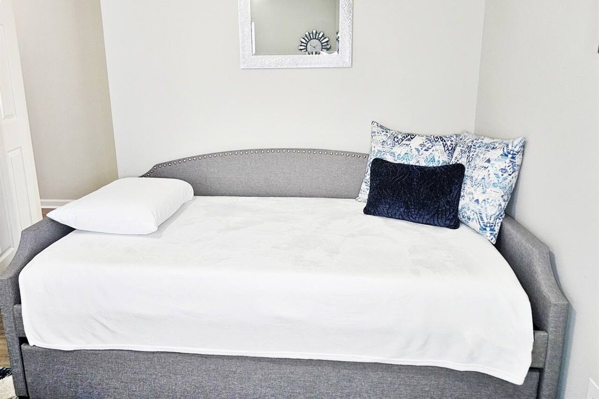 Day bed with a trundle bed underneath. Both beds are twin size. 