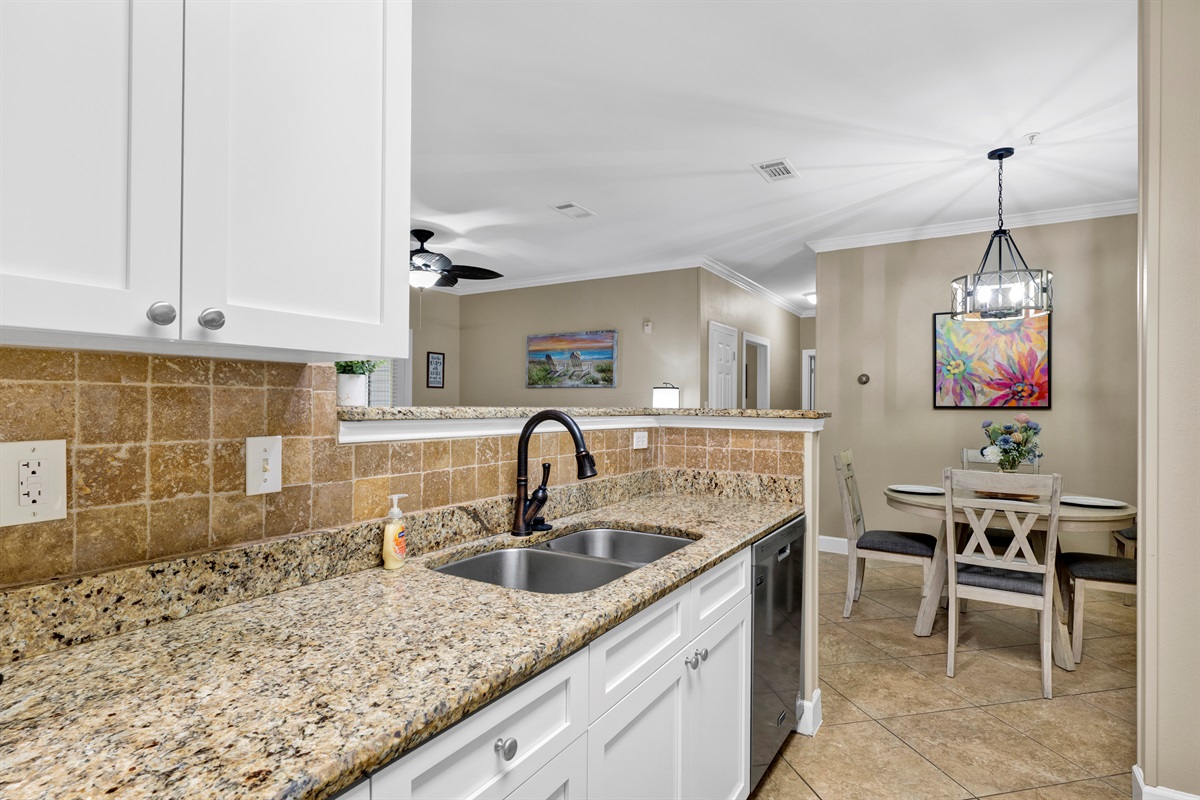 Kitchen with granite tops, stainless appliances and it is fully stocked with everything you need to prepare your meals 