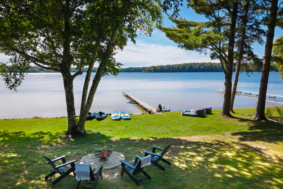 You have plenty of room to play outside with 100' of private lakefront. Relax in the chaises by the water, play a game of cornhole, and chill by the firepit at the end of the day for the sunset.
