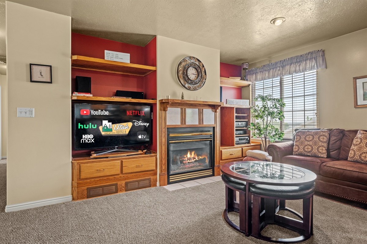 Rustic living room with smart TV and fireplace — perfect for relaxing after skiing.