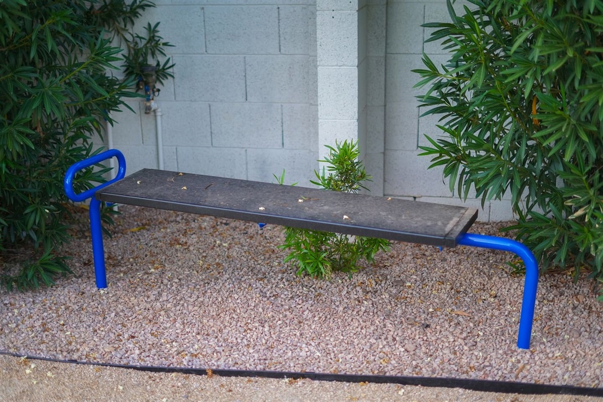 Transform your fitness routine at the outdoor exercise stations, complete with various bars for a versatile and invigorating workout experience.

Unleash the abs on this bench!