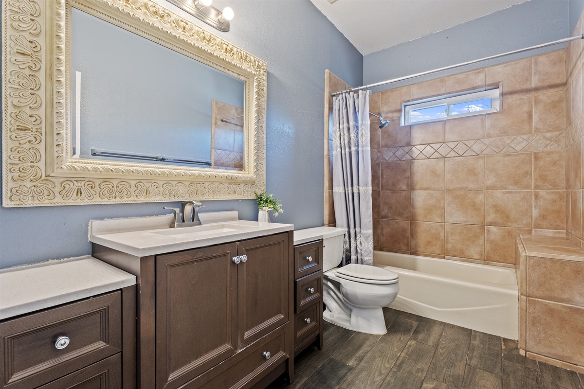 Relax and refresh in this stylish bathroom retreat featuring warm tile accents, a deep soaking tub, and spa-like vibes.