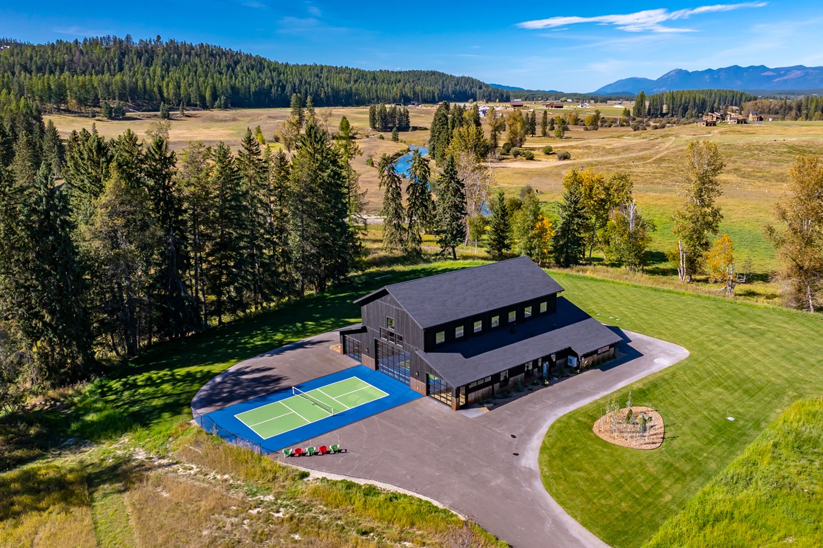 Aerial view of property with outdoor regulation sized pickleball court