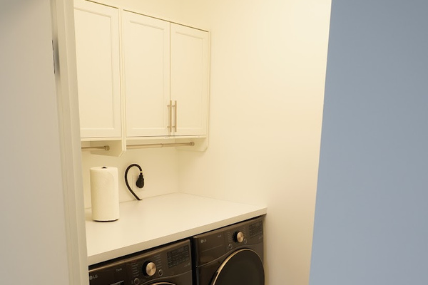 Laundry room with full size washer/dryer.
