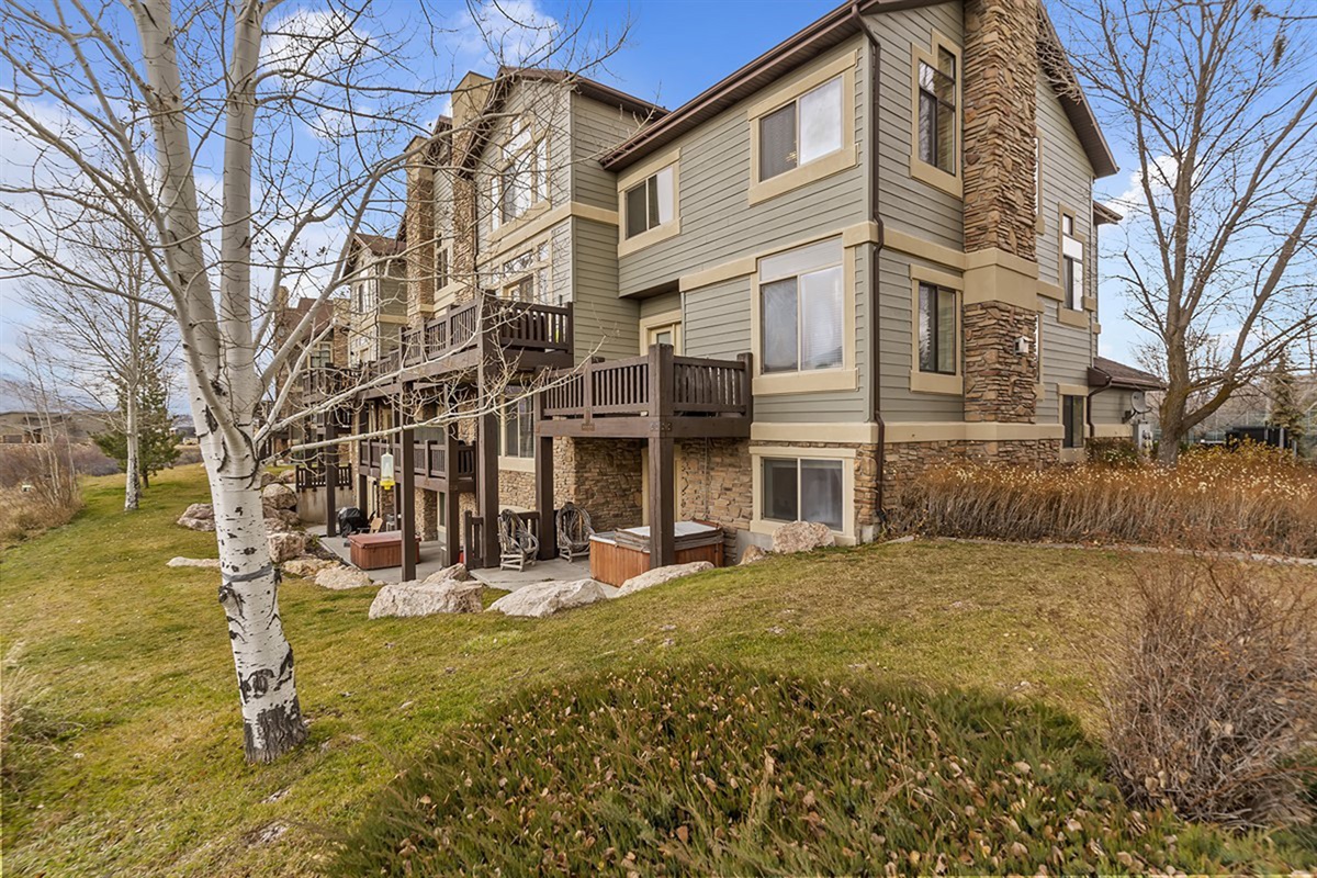 A side view of the townhome showcasing thoughtful architecture and landscaped surroundings for a refined residential feel.
