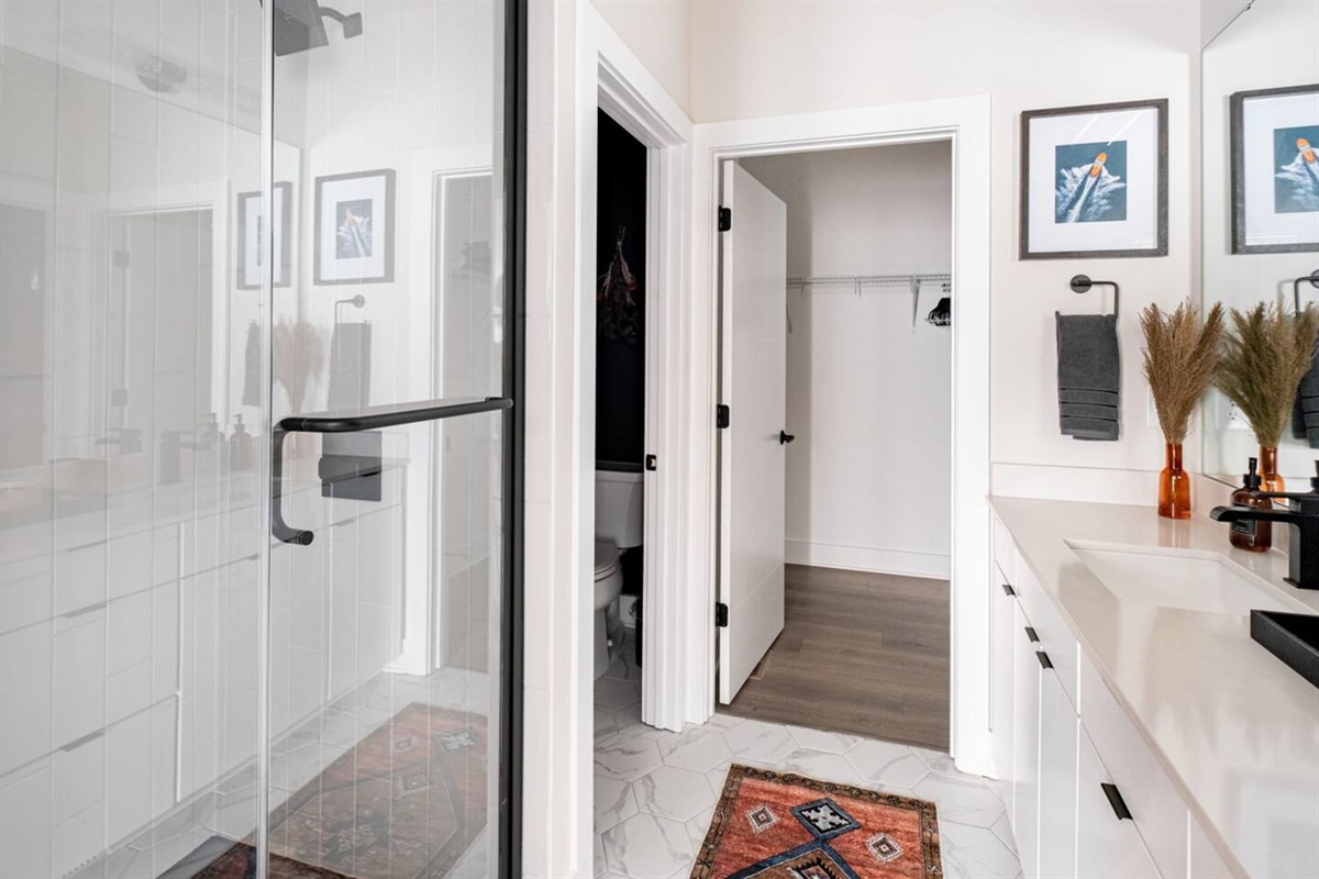 The primary king bedroom has a large ensuite bathroom. Double vanity, walk-in shower, full closet for plenty of clothing storage, and all essential toiletries provided.