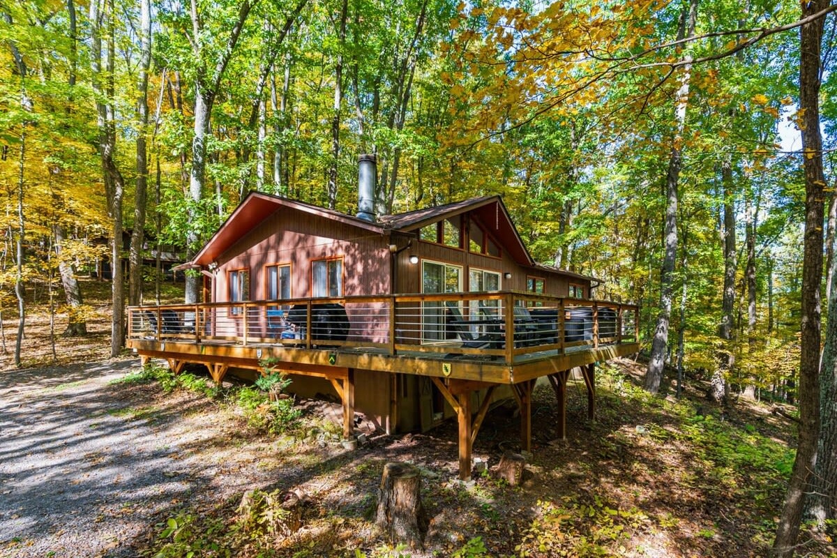 Unwind in the hot tub or take in the view from the deck — serene woods surround this charming Berkeley Springs chalet.