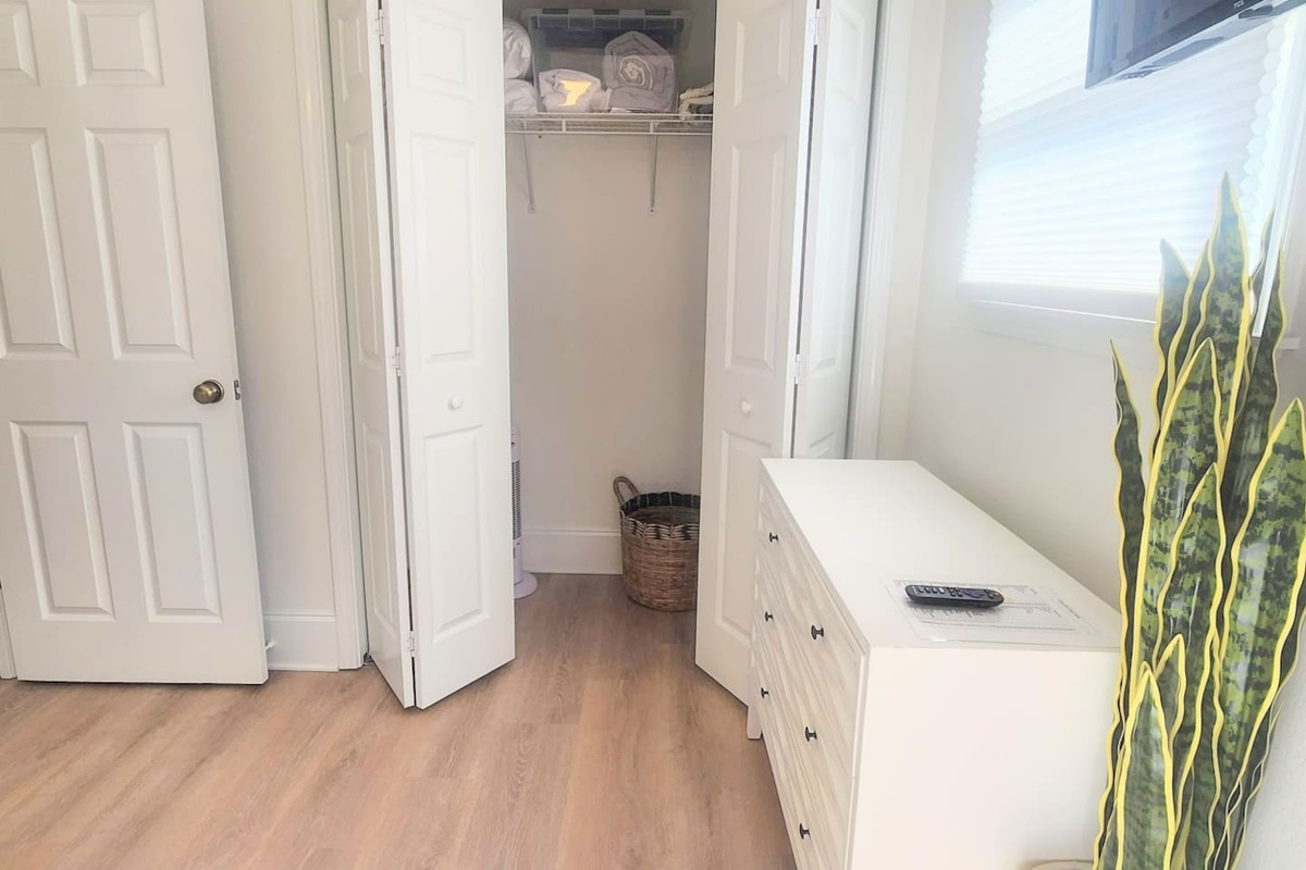 Hang up your clothes and actually unpack &mdash; the queen bedroom has enough storage to settle in for the week.